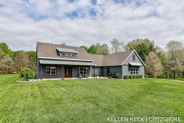 2263 136th Ave, Dorr, MI 49323 - view of front of property featuring a front lawn, a porch, a standing seam roof, and metal roof