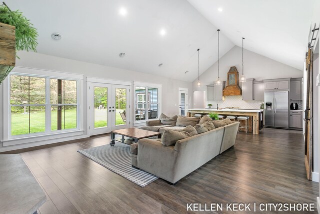 2263 136th Ave, Dorr, MI 49323 - living room with high vaulted ceiling, french doors, and dark wood finished floors