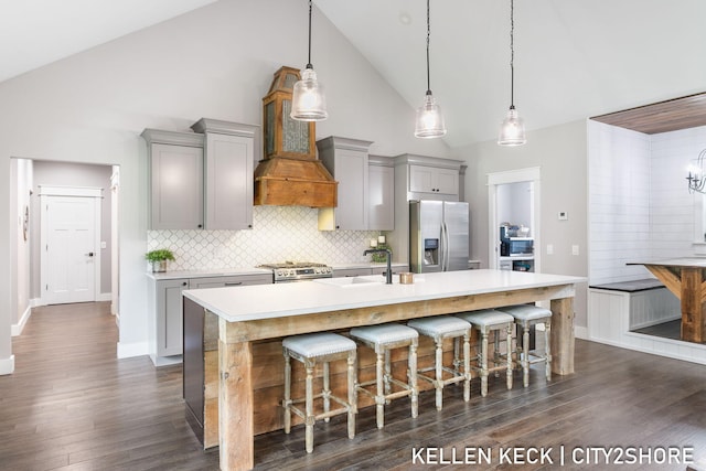 2263 136th Ave, Dorr, MI 49323 - kitchen with appliances with stainless steel finishes, gray cabinetry, high vaulted ceiling, a sink, and a center island with sink
