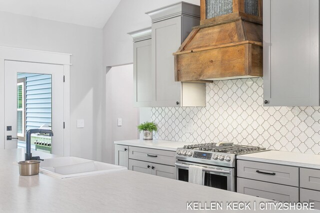 2263 136th Ave, Dorr, MI 49323 - kitchen with gas stove, gray cabinetry, a sink, light countertops, and vaulted ceiling