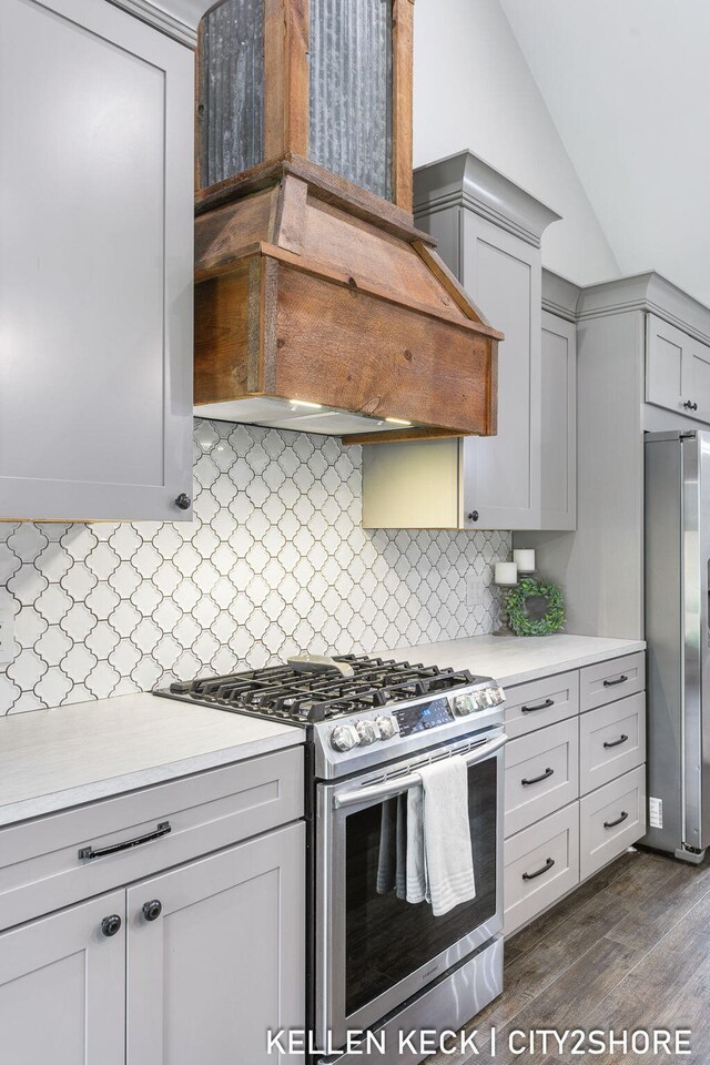 2263 136th Ave, Dorr, MI 49323 - kitchen featuring appliances with stainless steel finishes, custom exhaust hood, light countertops, lofted ceiling, and gray cabinets