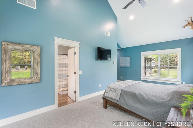 2263 136th Ave, Dorr, MI 49323 - carpeted bedroom featuring high vaulted ceiling, baseboards, ensuite bath, and ceiling fan