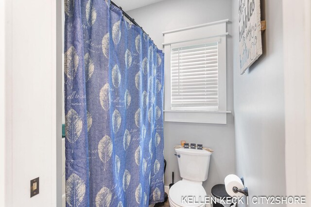 2263 136th Ave, Dorr, MI 49323 - bathroom with toilet and a shower with shower curtain