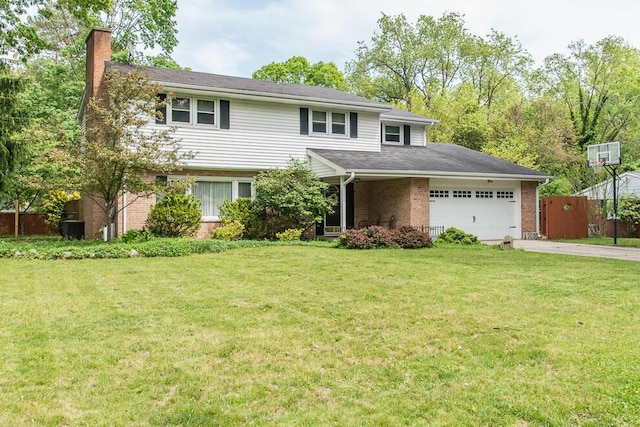 2707 Lomond Dr, Kalamazoo, MI 49008 - view of front of home featuring a chimney, a garage, brick siding, and driveway
