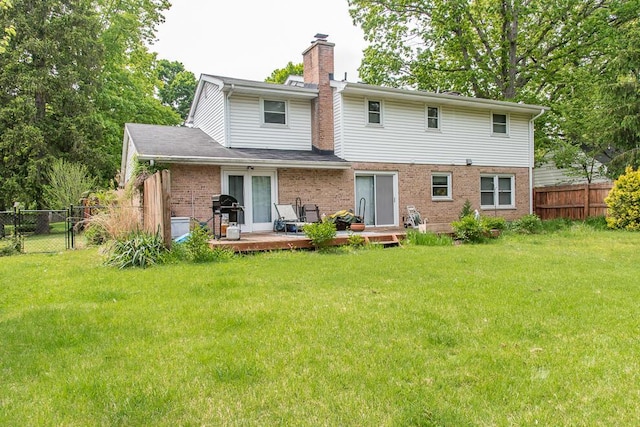 2707 Lomond Dr, Kalamazoo, MI 49008 - back of house featuring a chimney, a wooden deck, and brick siding