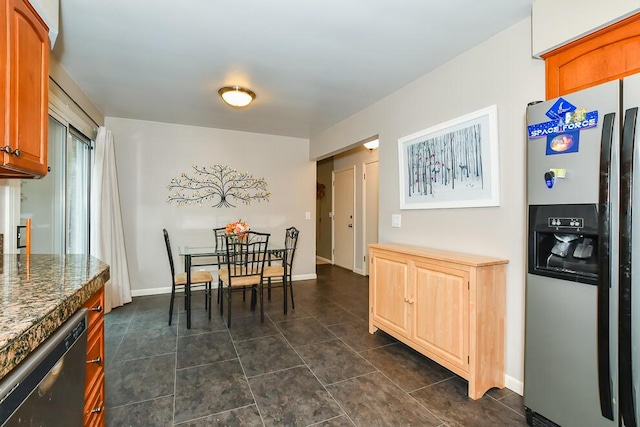 2707 Lomond Dr, Kalamazoo, MI 49008 - dining room featuring dark tile patterned floors and baseboards