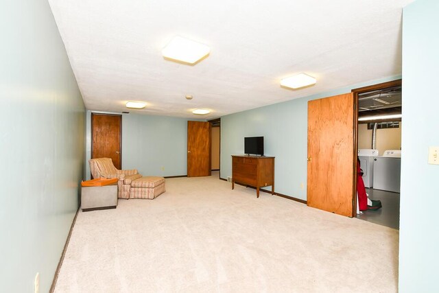 2707 Lomond Dr, Kalamazoo, MI 49008 - living area featuring washing machine and clothes dryer, baseboards, and carpet flooring