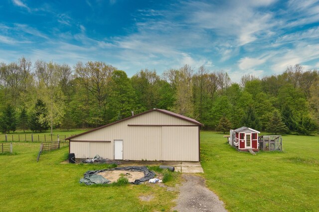 3725 S Creek Ln, Dryden, MI 48428 - view of pole building with asphalt driveway and a forest view
