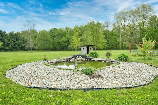 3725 S Creek Ln, Dryden, MI 48428 - view of green lawn with a storage shed and an outdoor structure