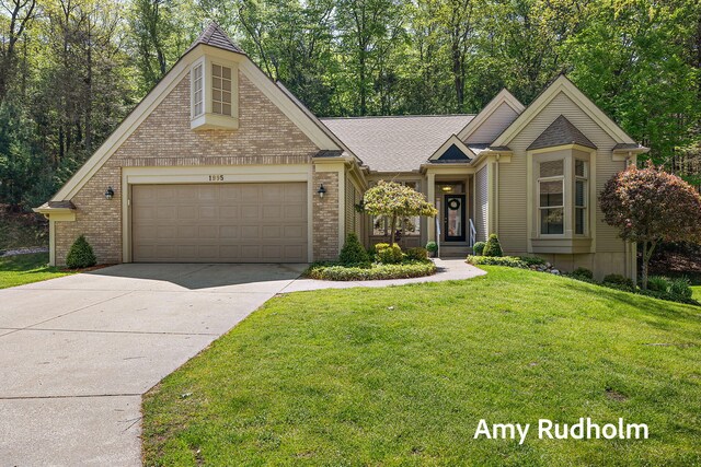 1995 W Glen Ct, Norton Shores, MI 49441 - view of front of house featuring brick siding, a garage, driveway, and a front yard