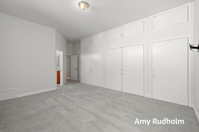 1995 W Glen Ct, Norton Shores, MI 49441 - unfurnished bedroom with two closets, light carpet, and baseboards