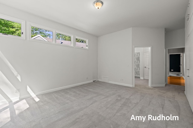 1995 W Glen Ct, Norton Shores, MI 49441 - unfurnished bedroom featuring multiple windows, carpet floors, and baseboards