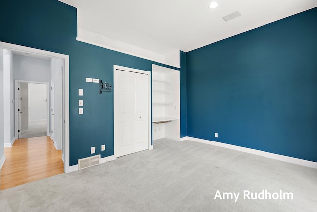 1995 W Glen Ct, Norton Shores, MI 49441 - unfurnished bedroom with carpet floors, a closet, baseboards, and recessed lighting