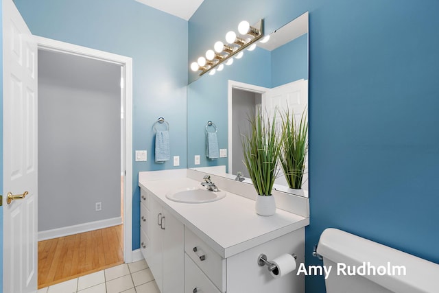 1995 W Glen Ct, Norton Shores, MI 49441 - half bathroom featuring toilet, vanity, baseboards, and tile patterned flooring