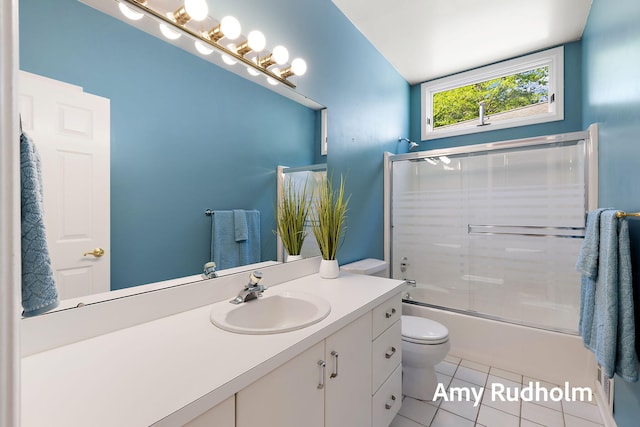 1995 W Glen Ct, Norton Shores, MI 49441 - bathroom featuring toilet, tile patterned flooring, vanity, and combined bath / shower with glass door