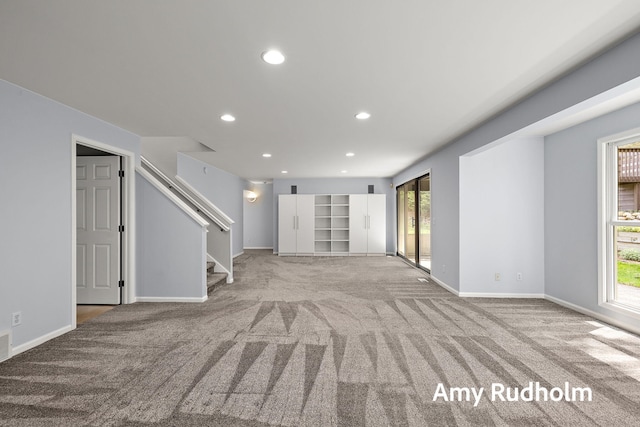 1995 W Glen Ct, Norton Shores, MI 49441 - unfurnished living room featuring carpet flooring, healthy amount of natural light, recessed lighting, and stairs