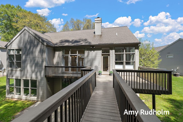 1995 W Glen Ct, Norton Shores, MI 49441 - rear view of property featuring a chimney, a wooden deck, and a yard