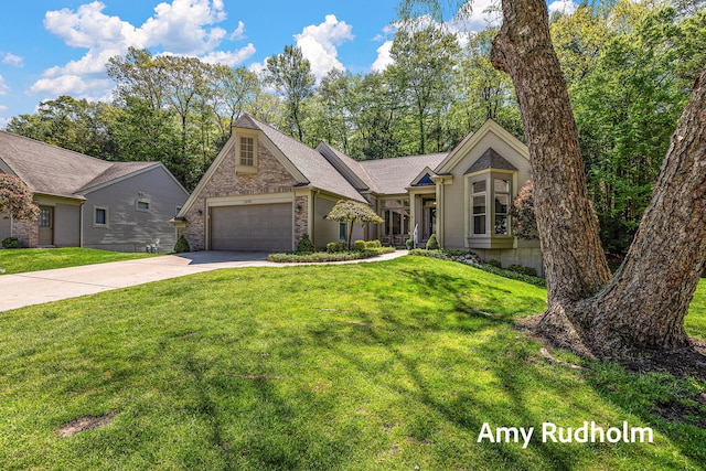 1995 W Glen Ct, Norton Shores, MI 49441 - view of front of house featuring concrete driveway, a front lawn, and an attached garage