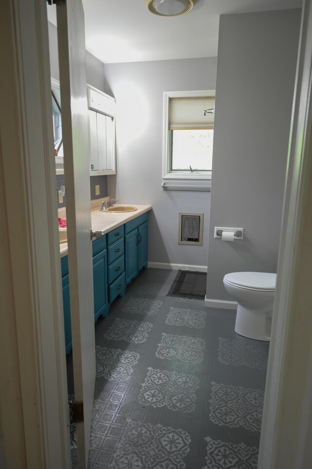 244 E Pearl St, Coldwater, MI 49036 - bathroom featuring baseboards, vanity, and toilet
