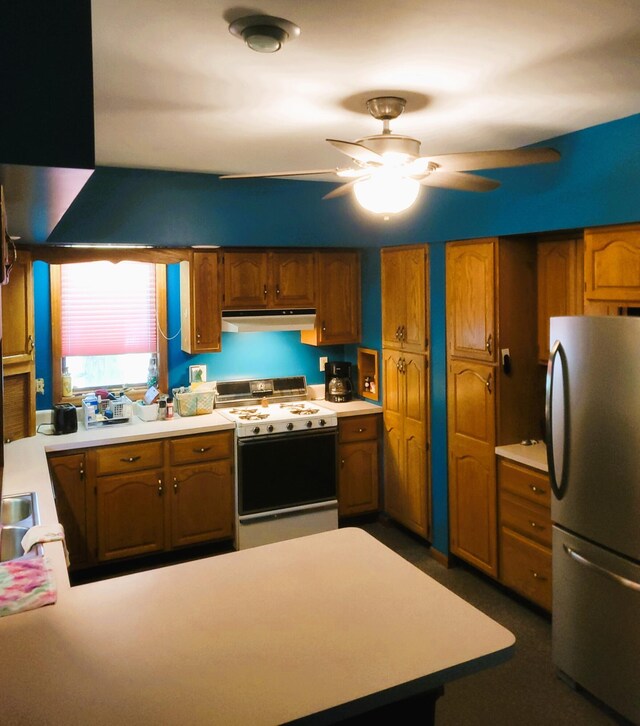 244 E Pearl St, Coldwater, MI 49036 - kitchen featuring freestanding refrigerator, white range with electric stovetop, under cabinet range hood, and light countertops