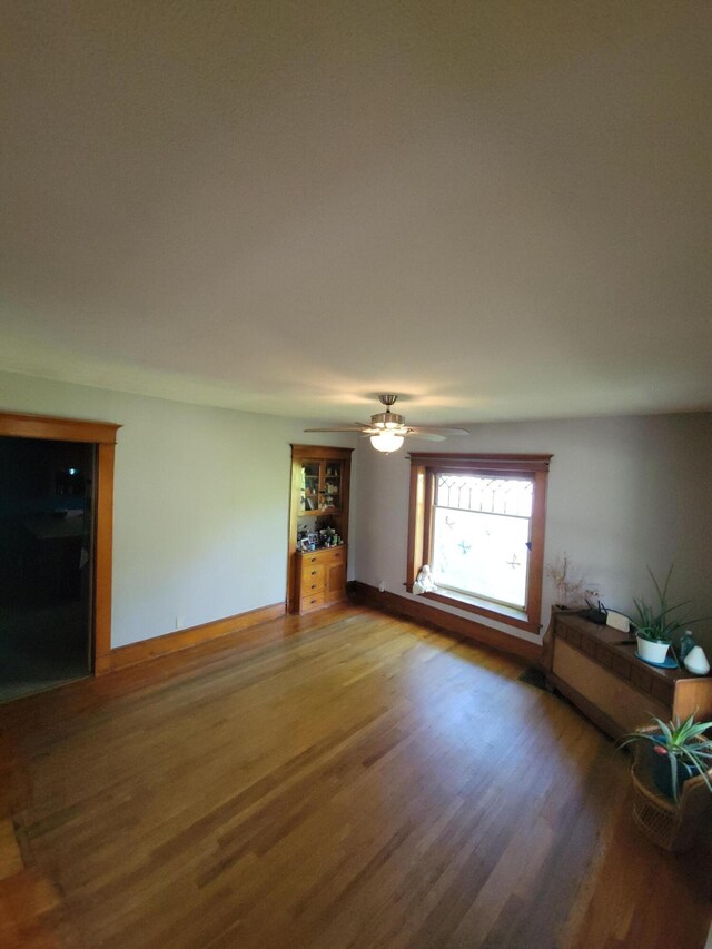244 E Pearl St, Coldwater, MI 49036 - unfurnished living room with wood finished floors and ceiling fan