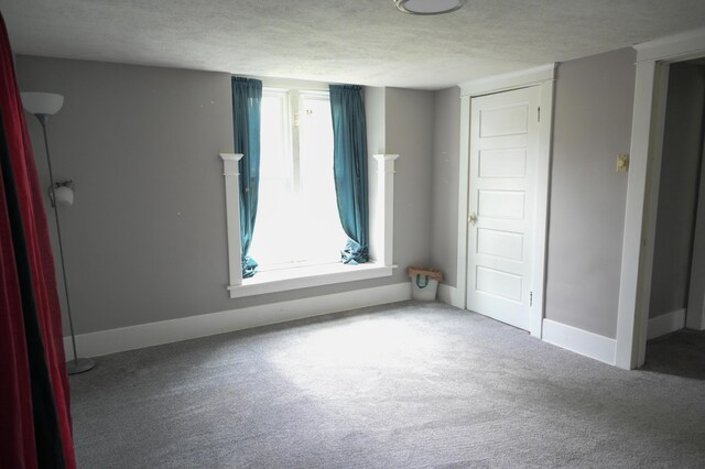 244 E Pearl St, Coldwater, MI 49036 - unfurnished bedroom featuring carpet, a textured ceiling, and baseboards