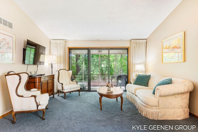 carpeted living room featuring lofted ceiling