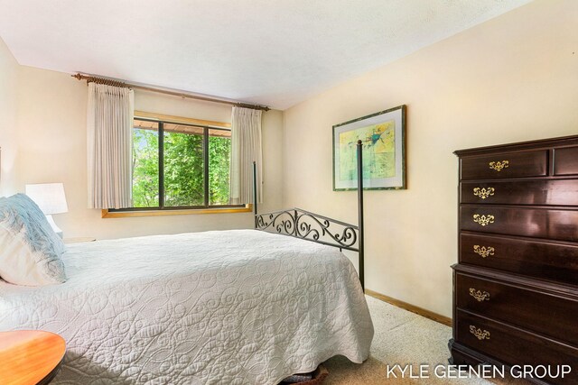 bedroom featuring carpet flooring and baseboards