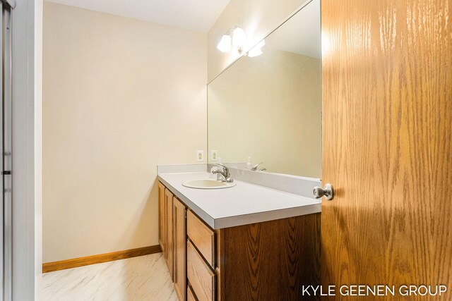 bathroom with vanity and baseboards