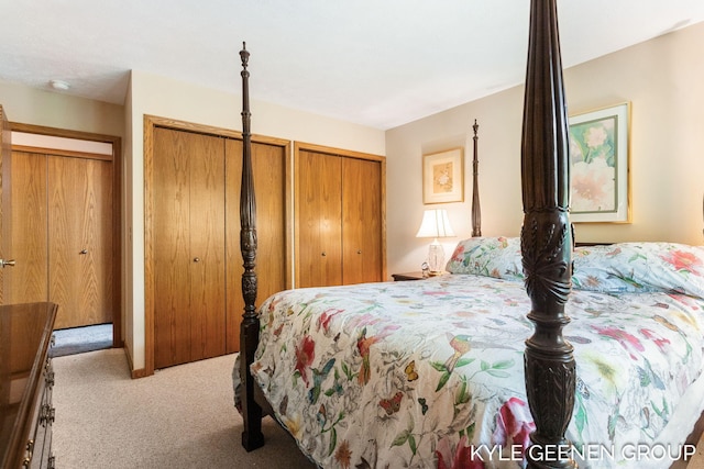 carpeted bedroom with multiple closets