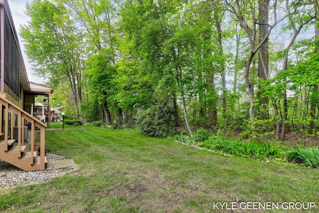 view of grassy yard with stairs
