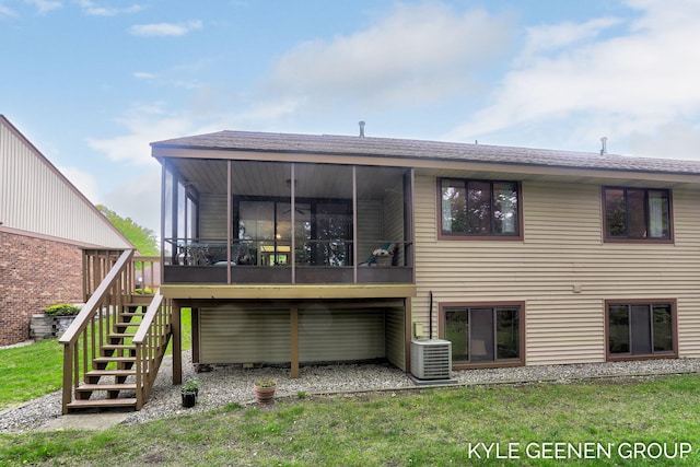 back of house with stairway, central AC, a sunroom, a yard, and roof with shingles