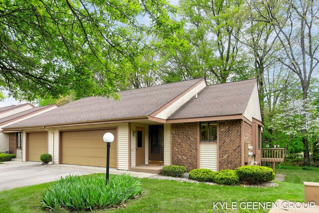 view of front of home with a garage, brick siding, concrete driveway, and a shingled roof