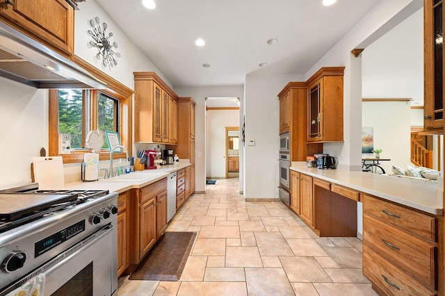 16431 Glassman Rd, Union Pier, MI 49129 - kitchen with appliances with stainless steel finishes, a sink, brown cabinetry, under cabinet range hood, and light countertops