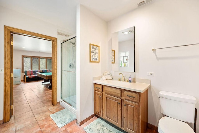 16431 Glassman Rd, Union Pier, MI 49129 - bathroom featuring a shower stall, connected bathroom, vanity, toilet, and tile patterned flooring