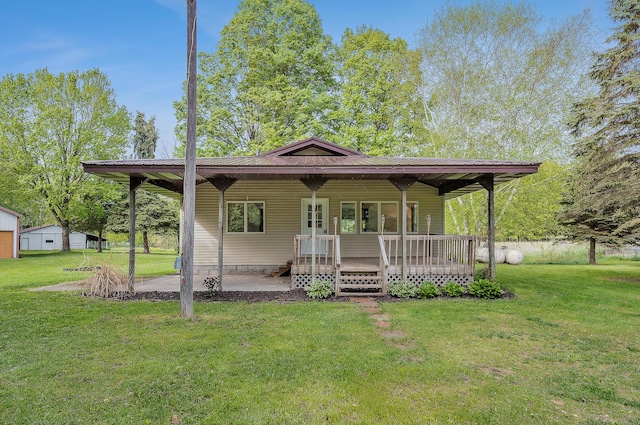 16436 45th Ave, Barryton, MI 49305 - view of front of property with a front lawn, a wooden deck, a patio, and metal roof