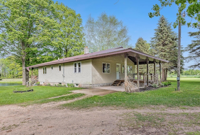 16436 45th Ave, Barryton, MI 49305 - view of side of property with a yard, a chimney, and entry steps