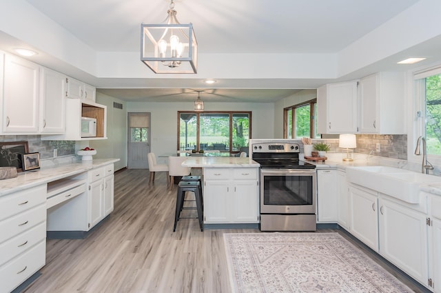 16436 45th Ave, Barryton, MI 49305 - kitchen featuring electric stove, a peninsula, a sink, white cabinets, and recessed lighting