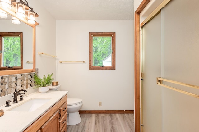 16436 45th Ave, Barryton, MI 49305 - bathroom with plenty of natural light, toilet, vanity, and wood finished floors