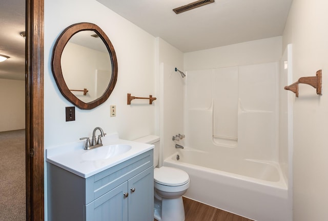 16436 45th Ave, Barryton, MI 49305 - bathroom with toilet, vanity, shower / bathtub combination, and wood finished floors