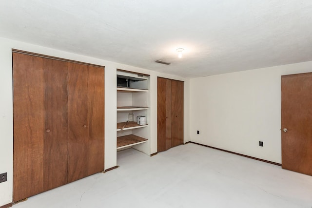 16436 45th Ave, Barryton, MI 49305 - unfurnished bedroom featuring multiple closets
