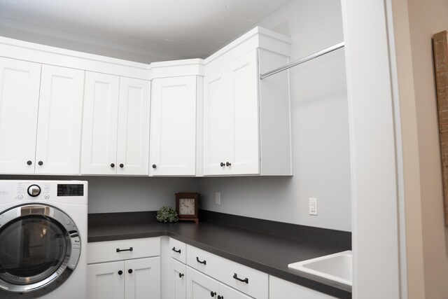 8182 Country Rail Dr SW, Byron Center, MI 49315 - washroom featuring washer / dryer and cabinet space