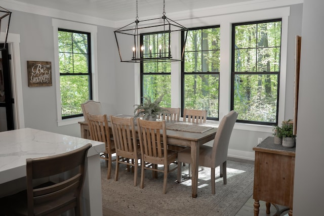 8182 Country Rail Dr SW, Byron Center, MI 49315 - dining space featuring a chandelier, crown molding, and baseboards