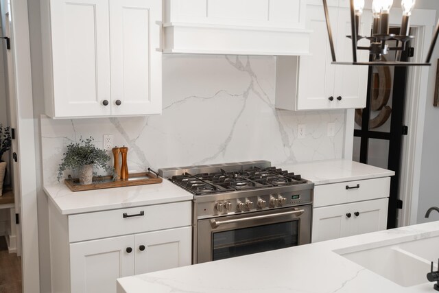 8182 Country Rail Dr SW, Byron Center, MI 49315 - kitchen featuring stainless steel range, white cabinets, a sink, and tasteful backsplash
