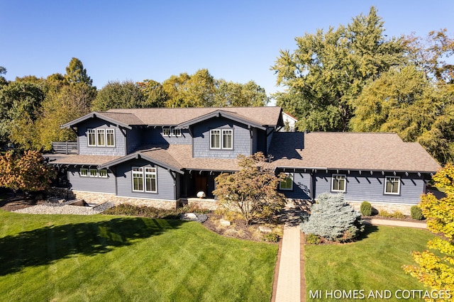 36 Randolph St, Douglas, MI 49406 - view of front of home with a front yard and a shingled roof
