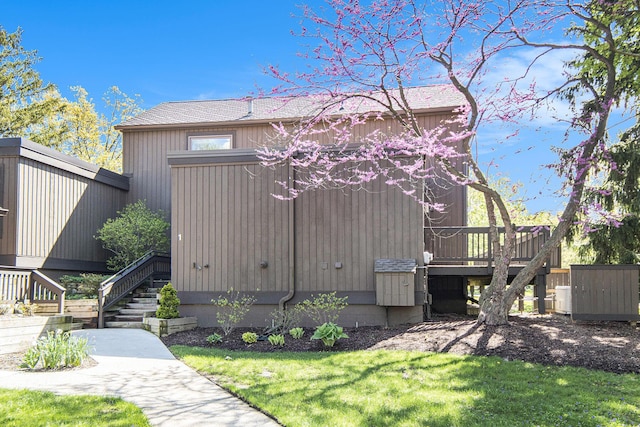 1 Northwick Ct, Ann Arbor, MI 48105 - rear view of property featuring stairway, a wooden deck, and a yard