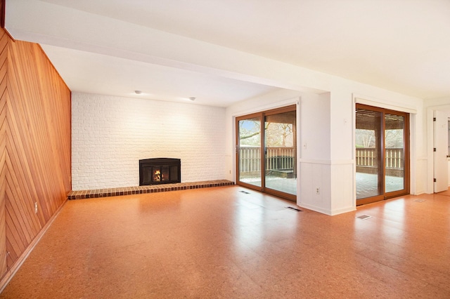 1 Northwick Ct, Ann Arbor, MI 48105 - unfurnished living room featuring a fireplace and a decorative wall