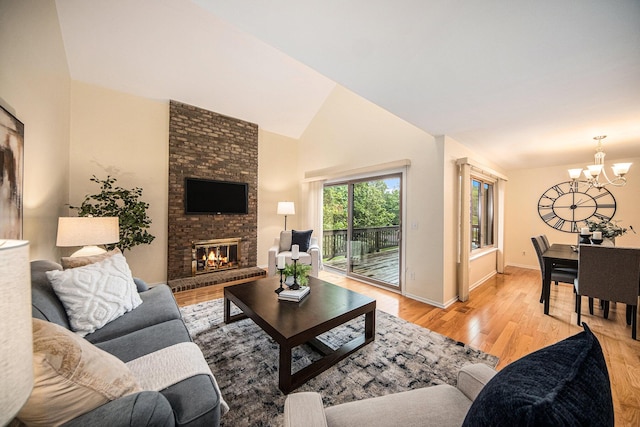 1 Northwick Ct, Ann Arbor, MI 48105 - living room featuring a chandelier, wood finished floors, a fireplace, high vaulted ceiling, and baseboards