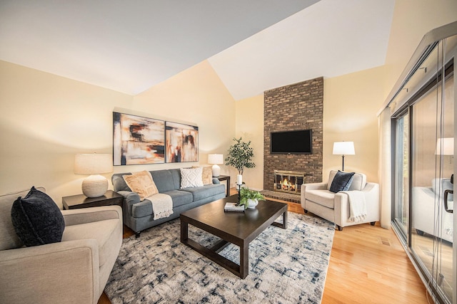 1 Northwick Ct, Ann Arbor, MI 48105 - living area featuring light wood-style flooring, a fireplace, and vaulted ceiling
