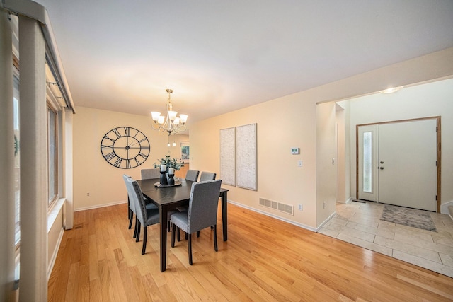 1 Northwick Ct, Ann Arbor, MI 48105 - dining space with light wood-style floors, a chandelier, baseboards, and healthy amount of natural light
